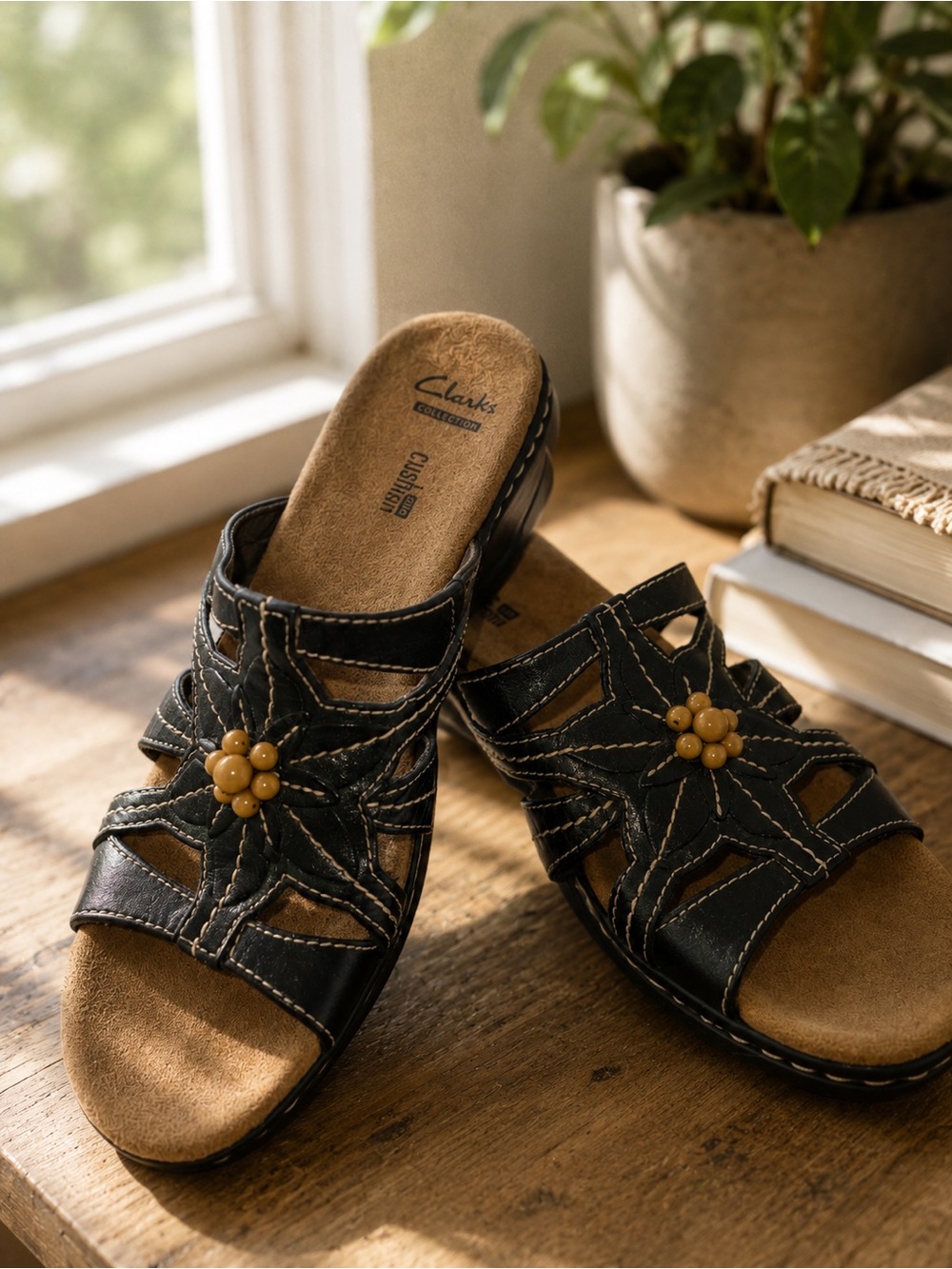 Clarks Women’s Black Leather Slip-On Sandals with Flower Accent